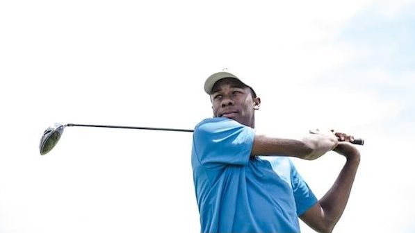 man swinging golf club