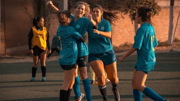 female athletes cheering on soccer field