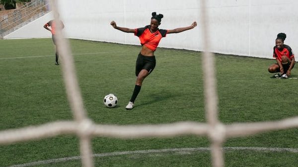 female athlete kicking soccer ball