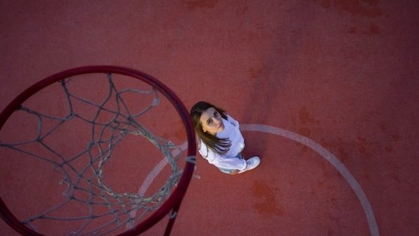 future WNBA basketball player looks up at the net