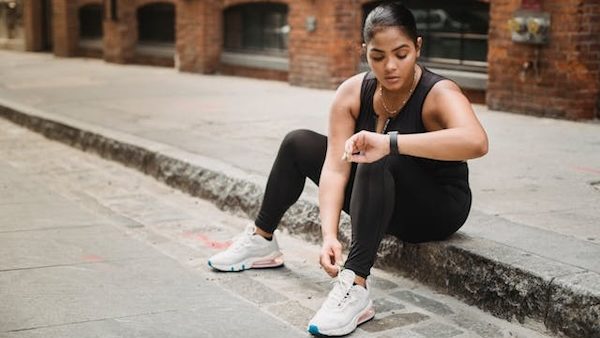 woman in athletic-wear and necklace