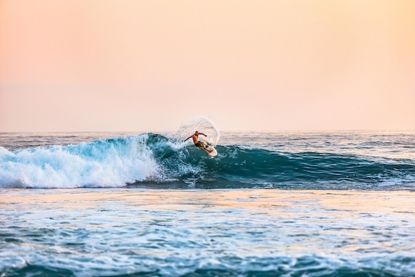 surfer catching wave at one of the best places to surf