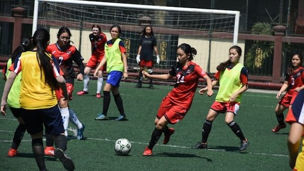 female soccer player kicking ball