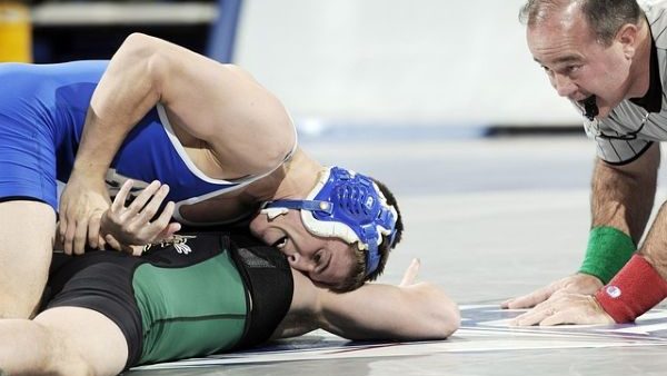 college wrestlers and referee