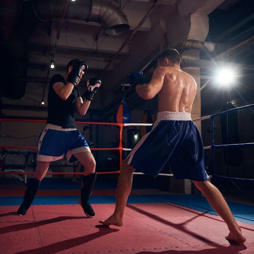 two male fighters training MMA in the ring, sports marketing